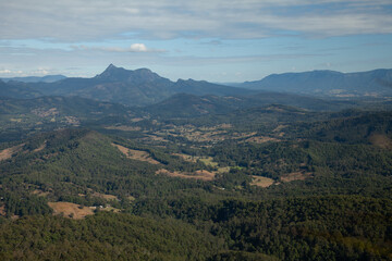 Naklejka premium Clear blue sky with an open view across the valley toward Mount Warning (Wollumbin), from summit of Mount Cougal, wide landscape perspective, Queensland, New South Wales, Australia.