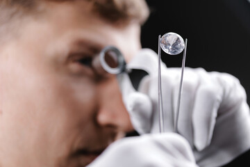 Meticulous jeweler examining diamonds gemstone with precision and focus in closeup gemstone sequence