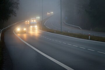 Naklejka premium Bad weather driving - foggy hazy country road. Motorway - road traffic. Winter time