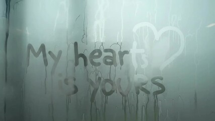 Heartfelt message on rainy window