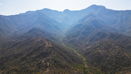 Naklejka premium Mountain landscape of Mayascón rising above rural valleys in Lambayeque, Peru