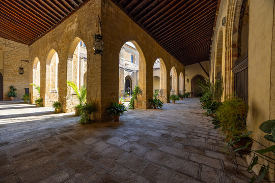 Stone arches forming cloister hallway in Baeza, Spain