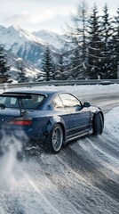 Naklejka premium A blue car drifts on a snowy road with mountains in the background, showcasing a dynamic winter driving scene.