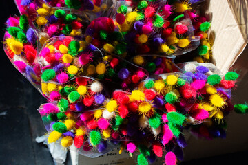 Beautiful multi colored artificial flowers background. flowers decor.