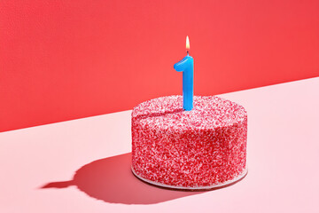 Birthday celebration cake with burning number one candle