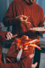 Festive Office Christmas Party with Delicious Food. A beautifully decorated office space with Christmas trees and festive lights, set up for a holiday party.