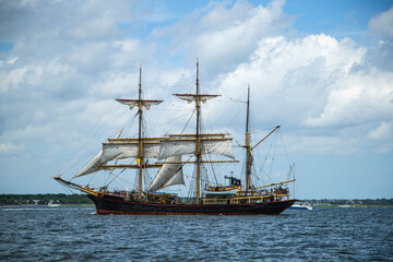 Tall ship sailing on open coastal water