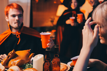Friends enjoying a Halloween party at a bar making a toast