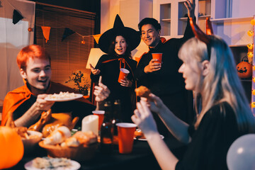 Friends enjoying a Halloween party at a bar making a toast