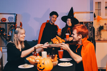 Friends enjoying a Halloween party at a bar making a toast