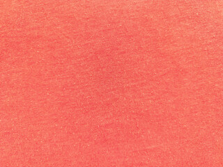 vibrant coral red fabric texture closeup speckled weave surface contrasts soft light blue backdrop...