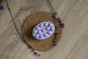 Natural soap with lavender and loofah on a stylish jute napkin is the perfect skin care and a pleasant fragrant accent in the bathroom. Gently cleanses, stimulates blood circulation and creates a spa