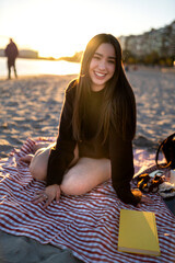 Young woman enjoying beach relaxation at sunset