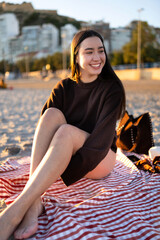 Young girl relaxing and smiling on winter beach