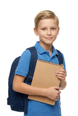 Obraz premium A boy stands smiling, holding a brown school book and wearing a blue shirt.