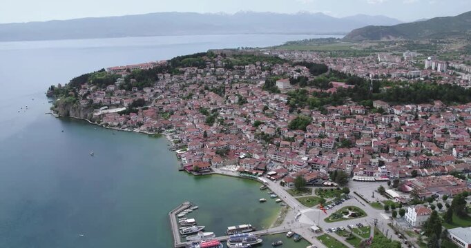 Aerial view of Ohrid. Different sail boats beside dock on ohrid lake with traditional house architecture on background