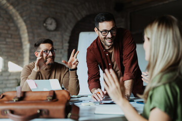 Small creative business team working together in a cozy modern office. Collaborative startup environment