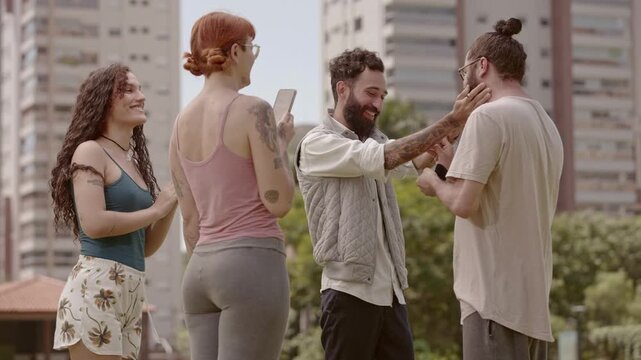 Happy gay couple hugging outdoors after a romantic proposal with a white rose