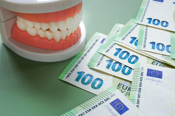 Dental insurance concept with jaw and euro banknotes. Healthcare costs.