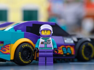 Obraz premium Tambov, Russian Federation - January 02, 2026 Lego NASCAR Next Gen Chevrolet Camaro ZL1 driver minifigure standing near his car. LEGO Speed Champions.