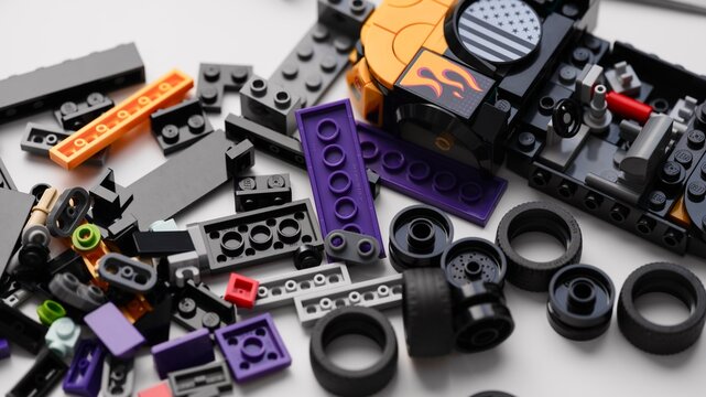 Tambov, Russian Federation - January 01, 2026 Lego Speed Champions Nascar Next Gen Chevrolet Camaro car kit build in progress with blocks, bricks and pieces on white table