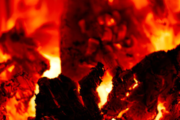 Glowing embers burning wood charcoal close up