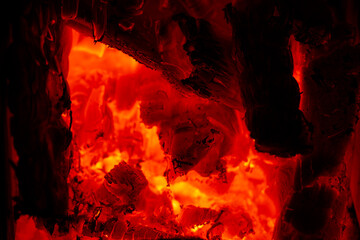 Glowing red embers burning from hot wood charcoal