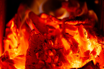 Glowing red hot embers burning in a fireplace