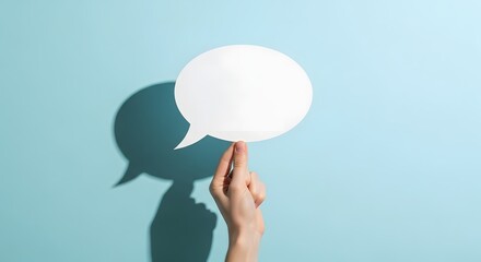 Hand delicately balancing a pristine white speech bubble, symbolizing the flow of ideas, conversation, and feedback against a vibrant blue backdrop, evoking clear communication