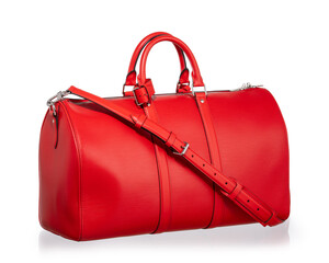 Large red travel bag with handles and a shoulder strap. Photographed on a white background with reflections.