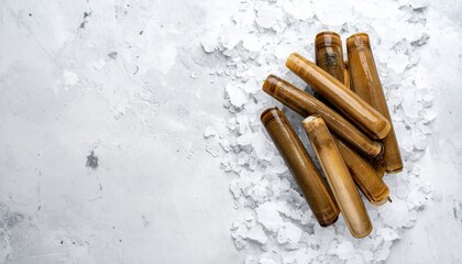 Several brown razor clams rest on crushed ice against a mottled white surface