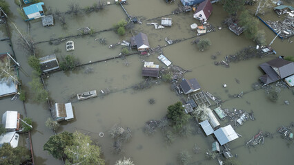 Aerial drone footage of a massive city flood with houses and streets submerged under water. Urban flooding caused by extreme weather and heavy rainfall, showing natural disaster impact on residential 