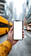 Hand holding smartphone with blank screen on city street