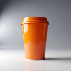 A vibrant orange disposable cup on a clean white surface