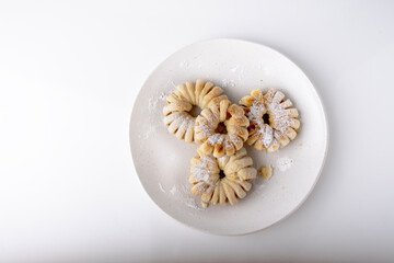 puff pastry buns on a white plate top view, homemade baked goods