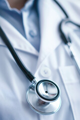 Doctor stethoscope hanging on white coat. Healthcare concept.