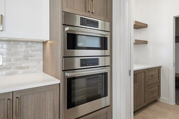 Kitchen with a silver oven and two ovens