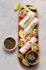 Spring rolls with vegetables, crab sticks and chili sauce © zoryanchik