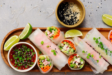 Spring rolls with vegetables, crab sticks and chili sauce © zoryanchik