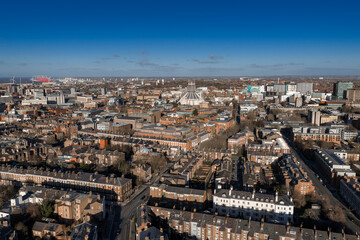 Aerial sunrise view of central Liverpool, UK. Liverpool Metropolitan Cathedral sits centered....