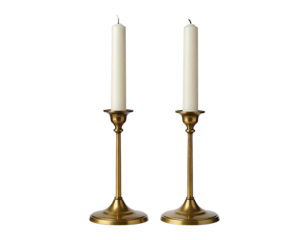 Two candles, one burnt, in bronze holders on black