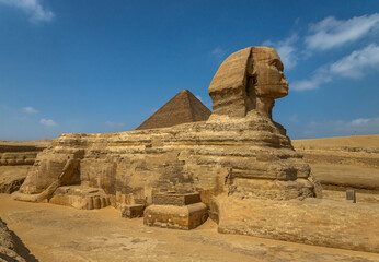 Horizontal view of the Great Sphinx of Giza with a pyramid in the background, Egypt. One of the most iconic ancient monuments, symbol of Egyptian civilization, history and archaeology