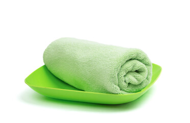 Green folded towel  arranged on a light surface, offering a clean space for branding and text placement.
