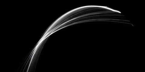 Abstract white curve trails against black background creative design