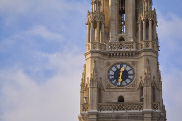 Close-up detail of the gilded clock face on the ornate Gothic to