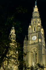 Illuminated main tower of the Vienna City Hall at night, showcas