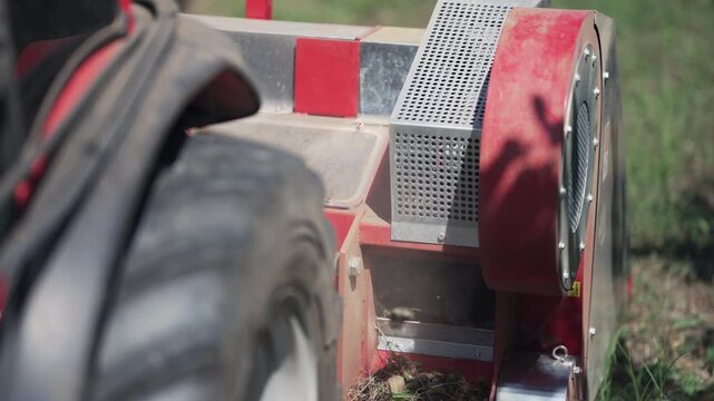 Combine harvester harvesting hazelnut crops from trees on agriculture plantation farm, cinematic selective focus slow motion shot