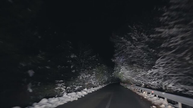 Drive pov at night on slippery icy road on extreme weather