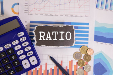 RATIO text on white paper on light background with charts paper