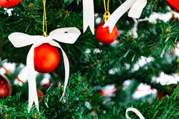 Red Christmas Ornaments Hanging on Green Pine Tree Branch